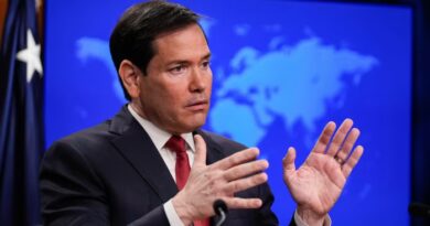 Marco Rubio gestures with both hands while speaking at a podium during a news conference.