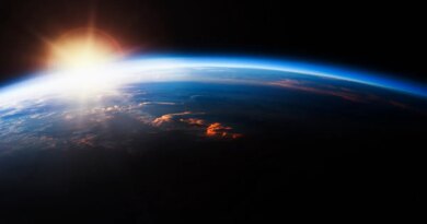 Sun seen from orbit rising over Earth.