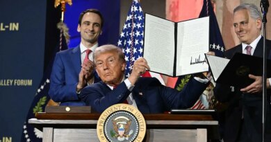 US President Donald Trump displays an executive order on artificial intelligence he signed at the "Winning the AI Race" AI Summit at the Andrew W.