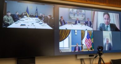 Volodymyr Zelenskyy sits at a conference table with Ukrainian officials, participating in a video call with Scott Bessent, Jared Kushner, and Larry Fink