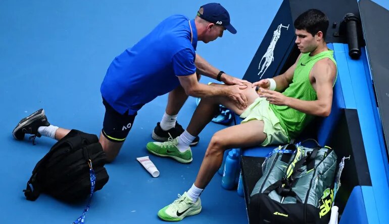 Spain's Carlos Alcaraz receives medical attention during his semi final match against Germany's Alexander Zverev