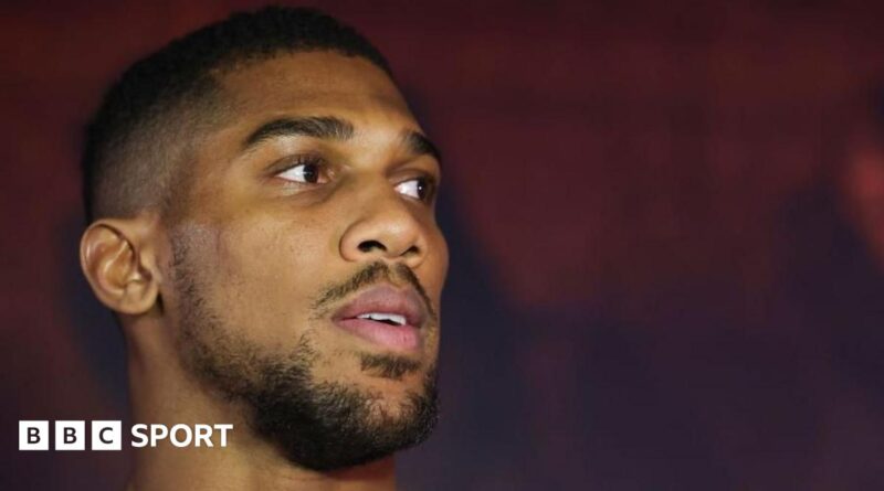 A picture of Anthony Joshua sat with four women