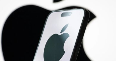 In this photo illustration, the logo of Apple Inc. is displayed on a smartphone screen, with the company's iconic black apple symbol visible in the background.