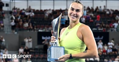 Aryna Sabalenka holds the trophy after winning the Brisbane International