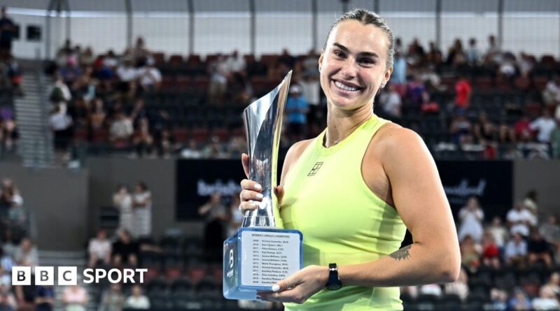 Aryna Sabalenka holds the trophy after winning the Brisbane International