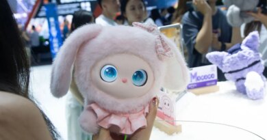 A general view shows fairgoers playing with an interactive doll at the Nubia booth at the Shanghai New Expo Center during the opening day of the World Artificial Intelligence Conference (WAIC) 2025 in Shanghai, China