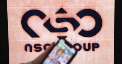 A photographic illustration shows a mobile phone near the NSO Group company logo on February 9, 2022 in the Israeli city of Netanya.