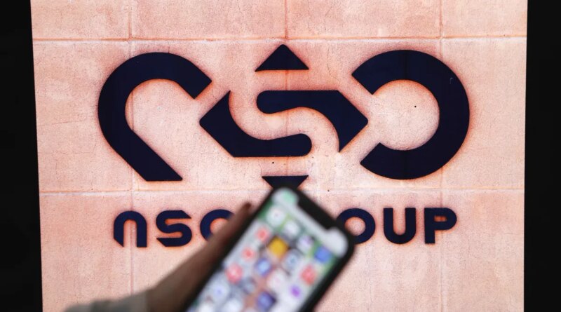 A photographic illustration shows a mobile phone near the NSO Group company logo on February 9, 2022 in the Israeli city of Netanya.