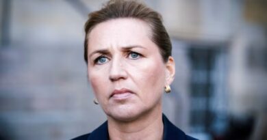 Mette Frederiksen appears serious while giving a press statement.