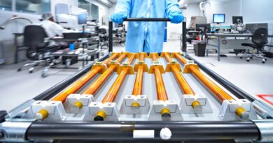 Copper rods being moved on a cart.