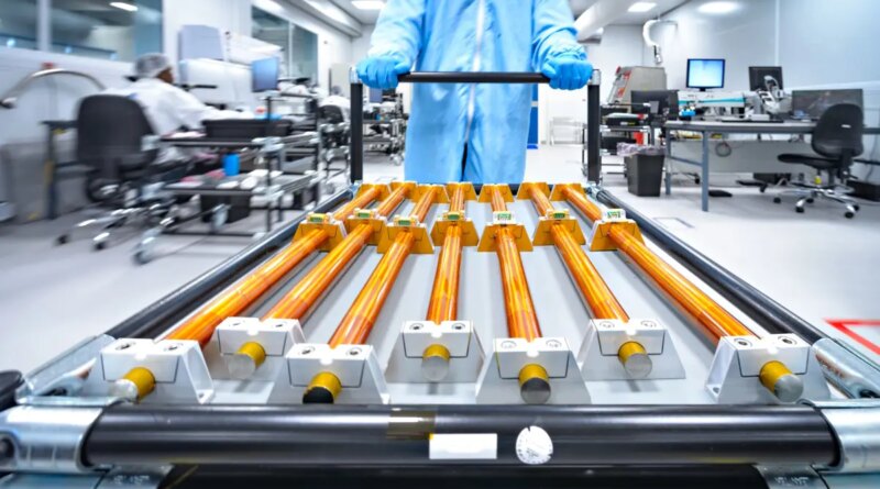 Copper rods being moved on a cart.