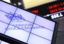 London Stock Exchange logo on a digital display with a stock ticker showing falling prices in the background.