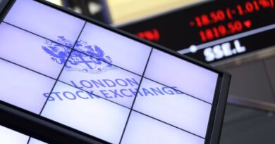 London Stock Exchange logo on a digital display with a stock ticker showing falling prices in the background.