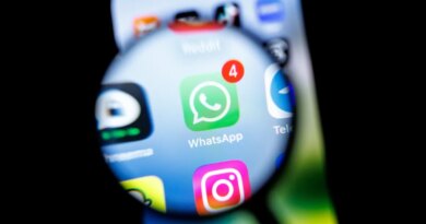 in this photo illustration, the Whatsapp app logo can be seen through a magnifying glass on the display of a smartphone.