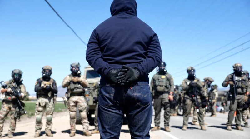 Federal agents block people protesting an ICE immigration raid at a nearby licensed cannabis farm on July 10, 2025 near Camarillo, California.