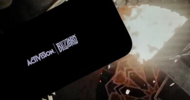 logo of ''Activision Blizzard'' is displayed on a mobile phone screen in front of a computer