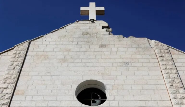 A view of the Holy Family Church which was damaged during the Israeli bombardment of the Gaza Strip, prior to the arrival of Palestinian Christians to celebrate Christmas Mass, in Gaza City, on December 24, 2025. The war was sparked by Hamas's October 7, 2023 attack on Israel, which resulted in the deaths of 1,221 people. Israel's retaliatory assault on Gaza has killed at least 69,733 people, according to figures from the health ministry that the UN considers reliable. (Photo by Omar AL-QATTAA / AFP)