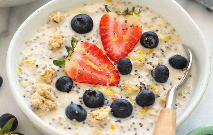 a bowl of chia pudding with berries and blueberries, similar to overnight oats.