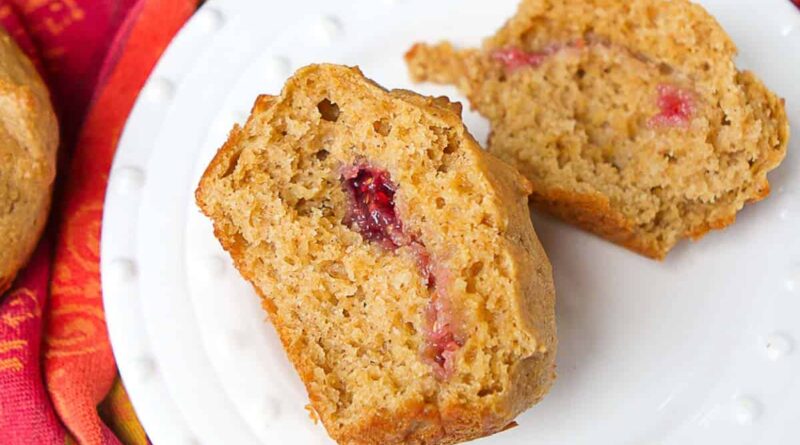 Peanut butter and jelly muffin on a white plate.
