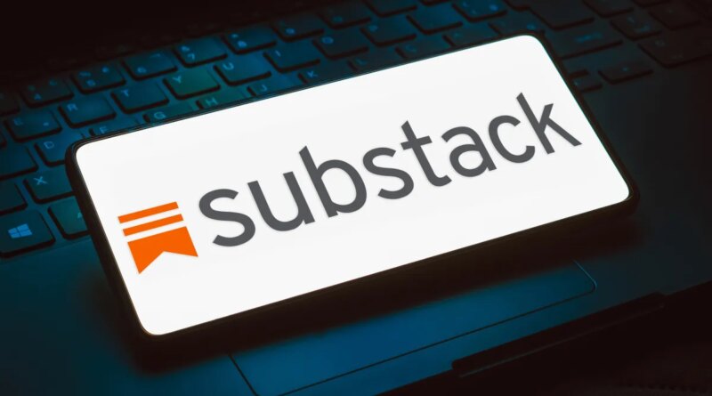 The Substack logo displayed on a phone that is resting on top of a keyboard