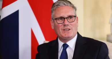 Keir Starmer speaking, seated in front of a large union jack flag