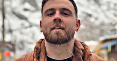 Erfan Soltani in an orange puffer jacket and woolen shirt.