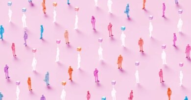 3D rendered conceptual illustration of numerous business figures evenly scattered across a soft pink background: solid colored human workers standing alongside identical translucent ghost-like figures, each translucent worker marked by a glowing “AI” symbol hovering above – powerful visualization of artificial intelligence replacing human workforce, solid employees mixed with their AI-replaced counterparts, automation displacing jobs, digital transformation eliminating roles, technological unemployment, workforce disruption, future of work with AI substitution, and the new era where real human workers are gradually replaced by artificial intelligence.