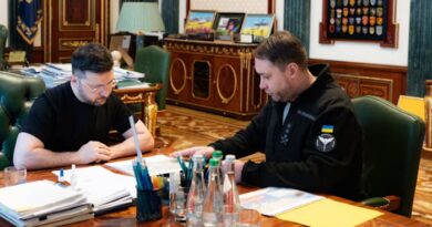 Volodymyr Zelensky and Kyrylo Budanov sit at a desk in an official office, reviewing documents together.