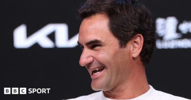 Roger Federer laughs during a news conference at the 2026 Australia Open