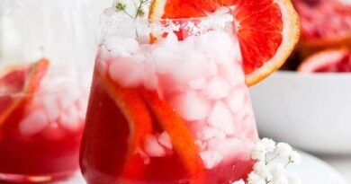 Two glasses of Blood Orange Margarita on a white plate.