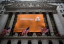 Conduent Inc. signage is displayed as American flags fly outside of the New York Stock Exchange (NYSE) in New York, U.S., on Tuesday, Jan. 3, 2017. U.S. stocks rose Tuesday, pointing to the biggest gain in a month for Wall Street's first session of the new year, helped by a string of robust economic data from China and Europe. Photographer: Michael Nagle/Bloomberg via Getty Images