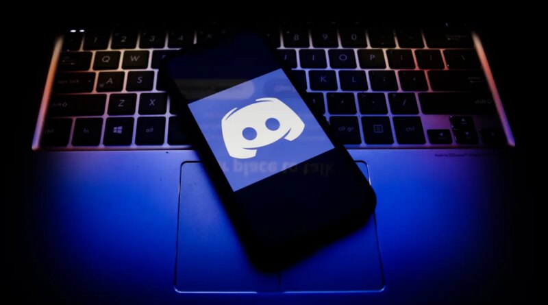 Discord logo displayed on a phone screen and a keyboard.
