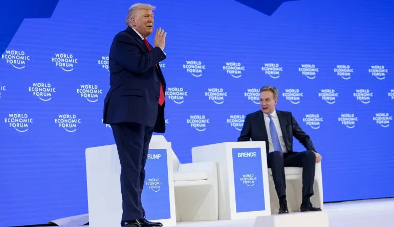 U.S. President Donald Trump gestures, as he stands next to the President and CEO of the World Economic Forum Borge Brende during the 56th annual World Economic Forum (WEF), in Davos, Switzerland, January 21, 2026. REUTERS/Jonathan Ernst