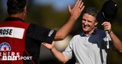 Justin Rose of England reacts with his caddie Mark Fulcher after his winning putt on the 18th green during the final round of the Farmers Insurance Open