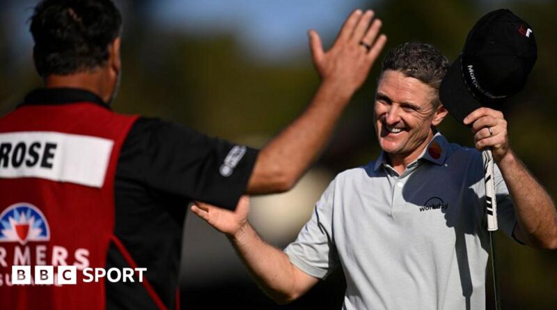 Justin Rose of England reacts with his caddie Mark Fulcher after his winning putt on the 18th green during the final round of the Farmers Insurance Open