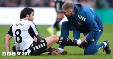 Newcastle midfielder Sandro Tonali gets treatment for an injury during the Premier League game against Aston Villa