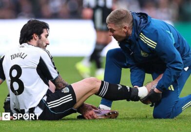 Newcastle midfielder Sandro Tonali gets treatment for an injury during the Premier League game against Aston Villa