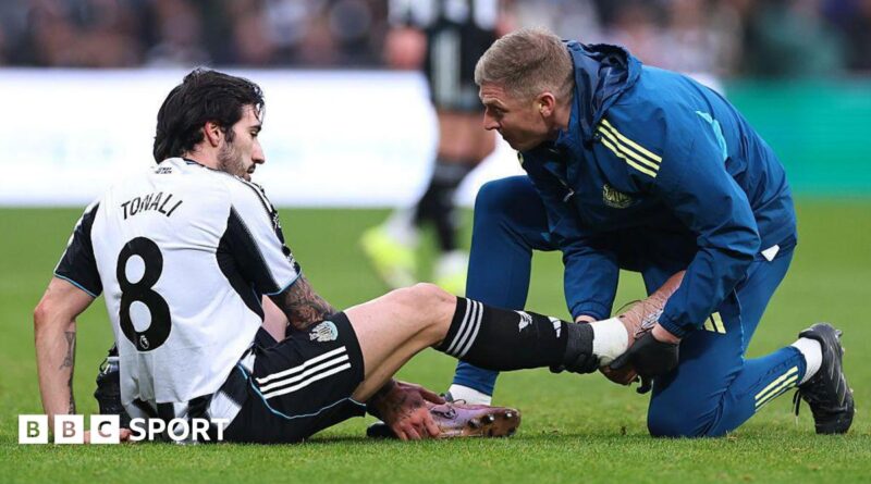 Newcastle midfielder Sandro Tonali gets treatment for an injury during the Premier League game against Aston Villa