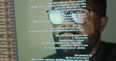Man studying a see-through display depicting Python computer coding.