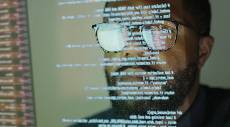 Man studying a see-through display depicting Python computer coding.