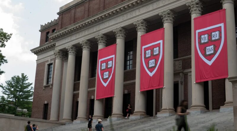 People walk past the Harry Elkins Widener Memorial Library on Harvard's campus on June 5, 2025.