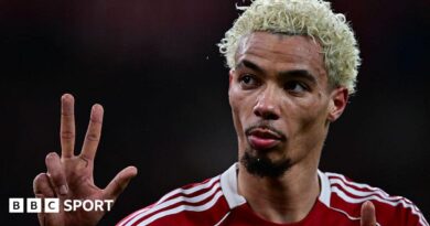 Hugo Ekitike gestures the score to Newcastle fans at Anfield