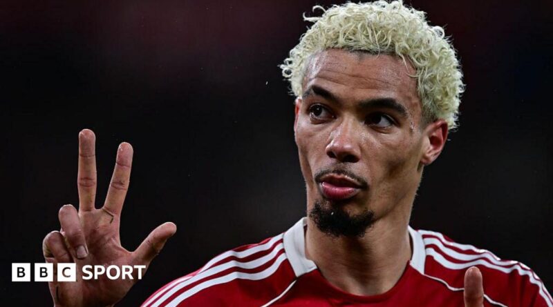 Hugo Ekitike gestures the score to Newcastle fans at Anfield