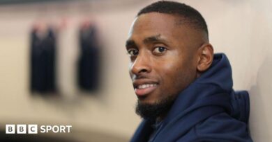 Joel Fearon smiles while wearing his training kit