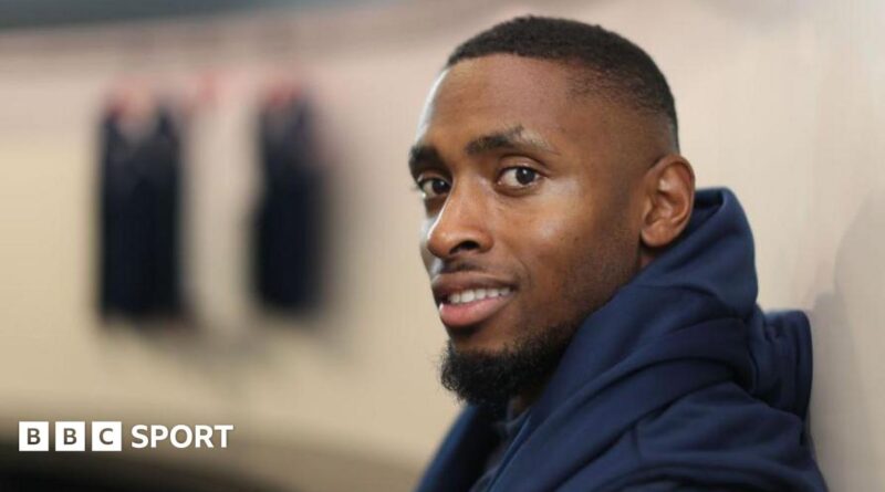 Joel Fearon smiles while wearing his training kit