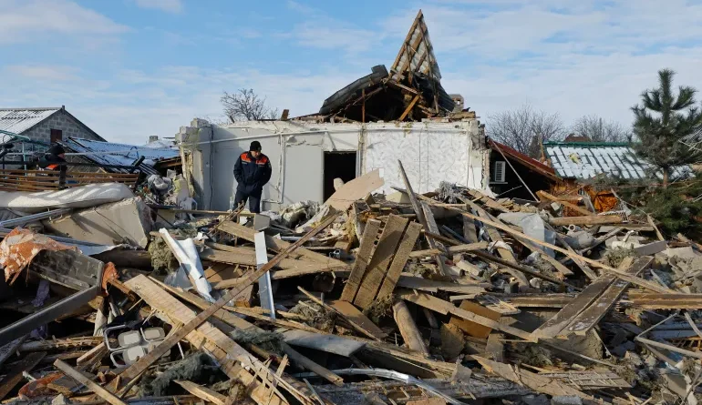 Members of Russia's emergencies ministry work on the ruins of a house, which was destroyed during what Russian-installed authorities called a recent Ukrainian drone attack, in the course of Russia-Ukraine conflict in the settlement of Sartana in the Donetsk region, a Russian-controlled area of Ukraine, February 1, 2026. REUTERS/Alexander Ermochenko