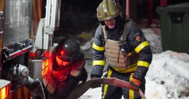 Ukrainian emergency workers are seen at the site of an apartment building that was damaged following a Russian air attack in Kyiv