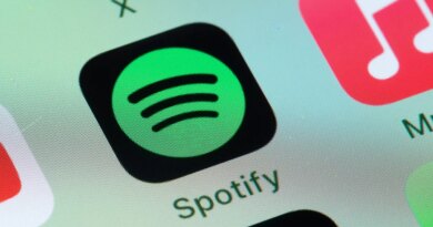 Spotify, Apple Music on smart phone screen.