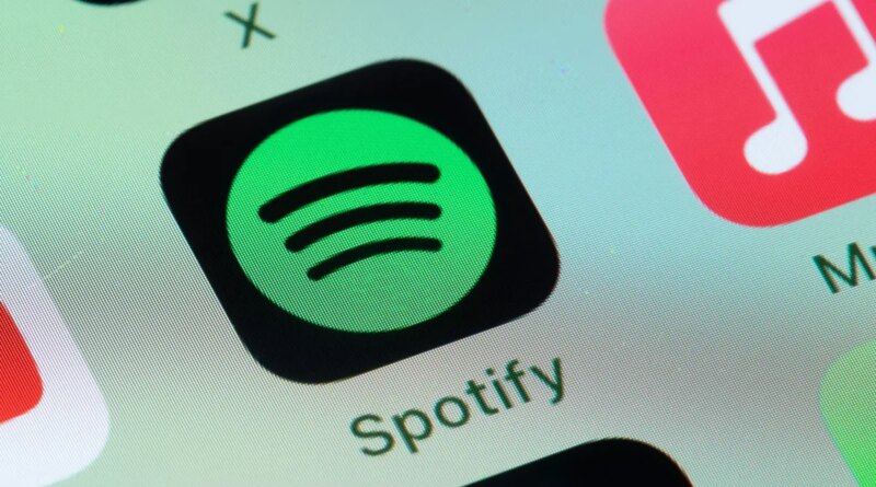 Spotify, Apple Music on smart phone screen.