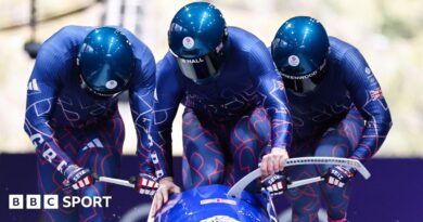 Team GB push the sled in the first heat of the bobsleigh at Cortina sliding centre